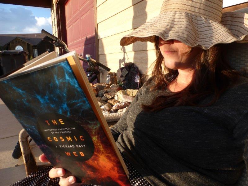 Natalie reads the Cosmic Web book at sunset